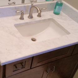 cherry vanity and wide spread lavatory faucet in 3/4 bath in walk-out basement