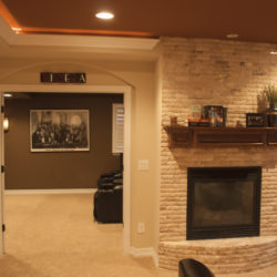 basement theater entry and fireplace overview