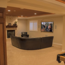 fireplace and full height stone surround in finished basement