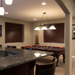 Parker, Colorado basement finish with walk behind wet bar, double arch ceiling detail and pool table