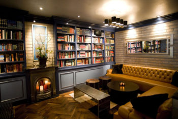 cozy library-style room with floor-to-ceiling bookshelves