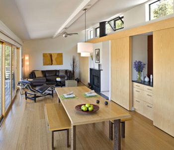 A modern open-plan A-frame style home with a wooden sloped ceiling