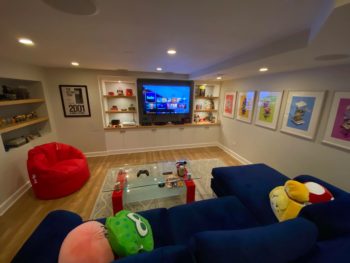 cozy basement media room with a dark ceiling