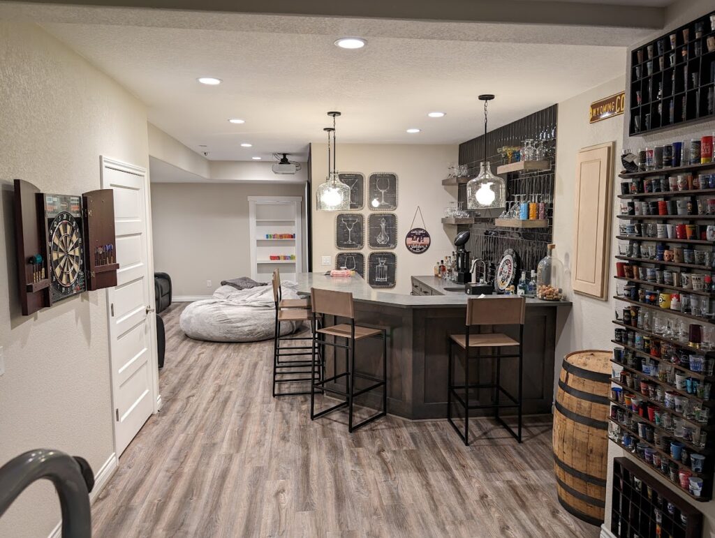 basement entertainment area with a wet bar in the foreground