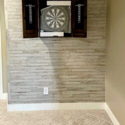 A dartboard mounted inside a recessed dark alcove or cabinet
