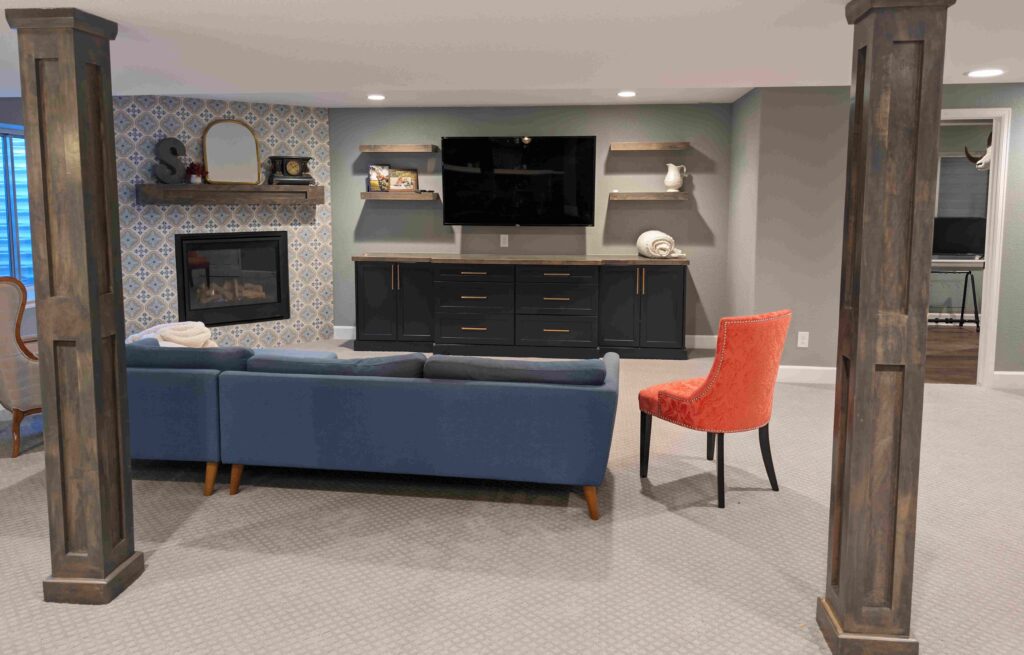 basement living room with a blue sectional sofa