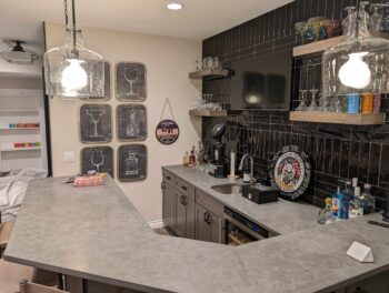 modern basement wet bar with a gray counter
